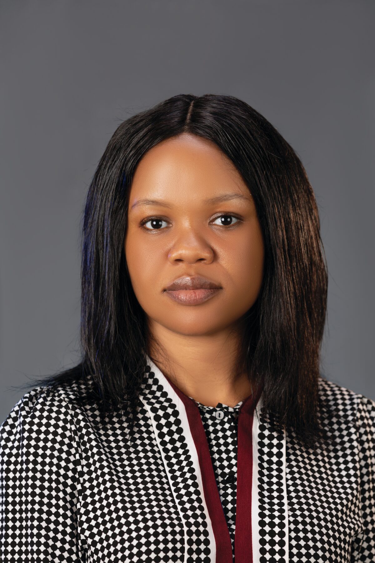 Woman with shoulder-length hair and a suit jacket.