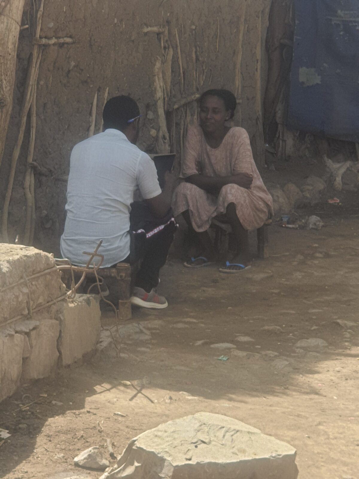 enumerator in Ethiopia collecting data from a woman